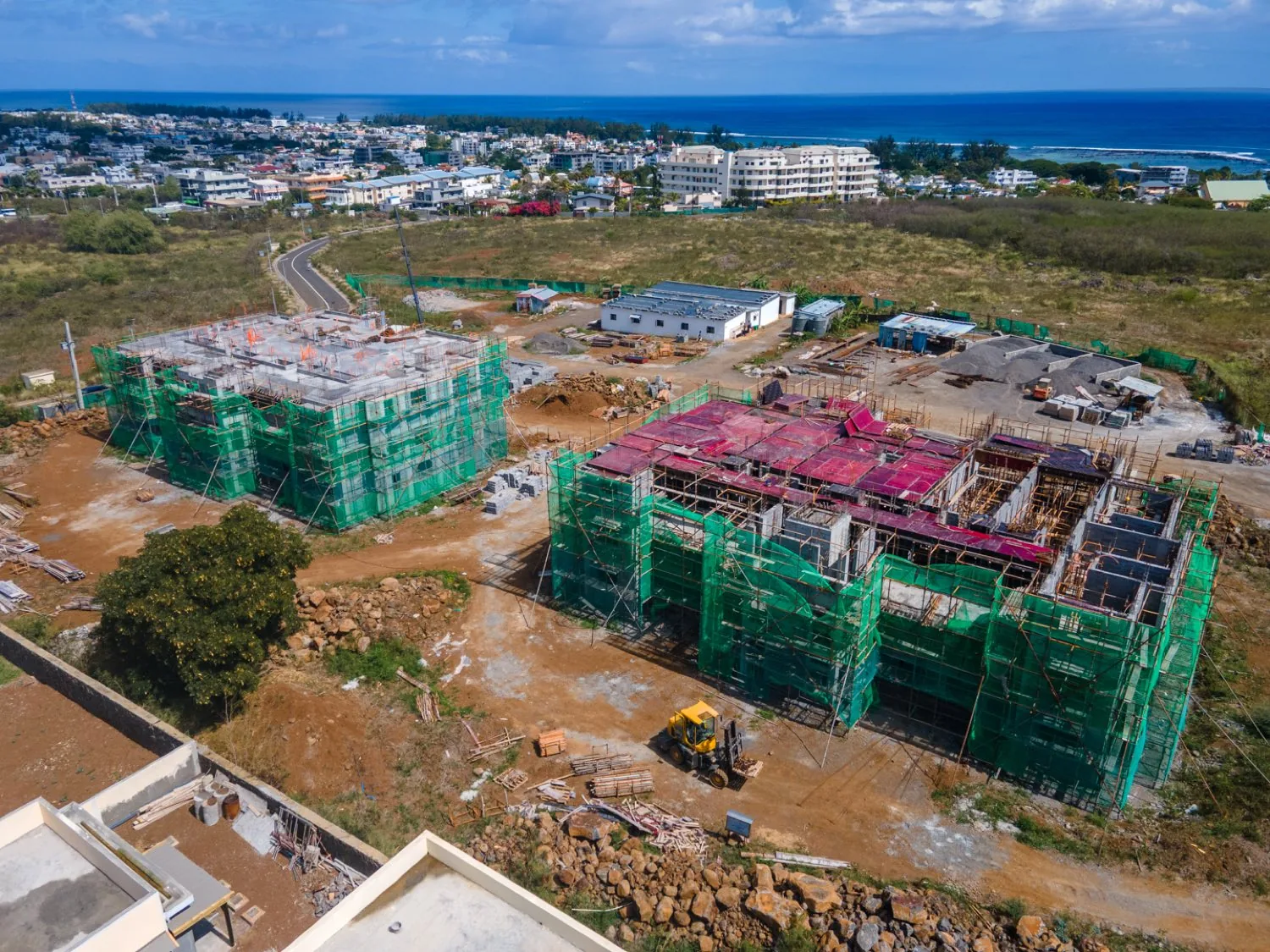 Aerial view of the two Anna City blocks under construction with Flic en Flac and the lagoon behind
