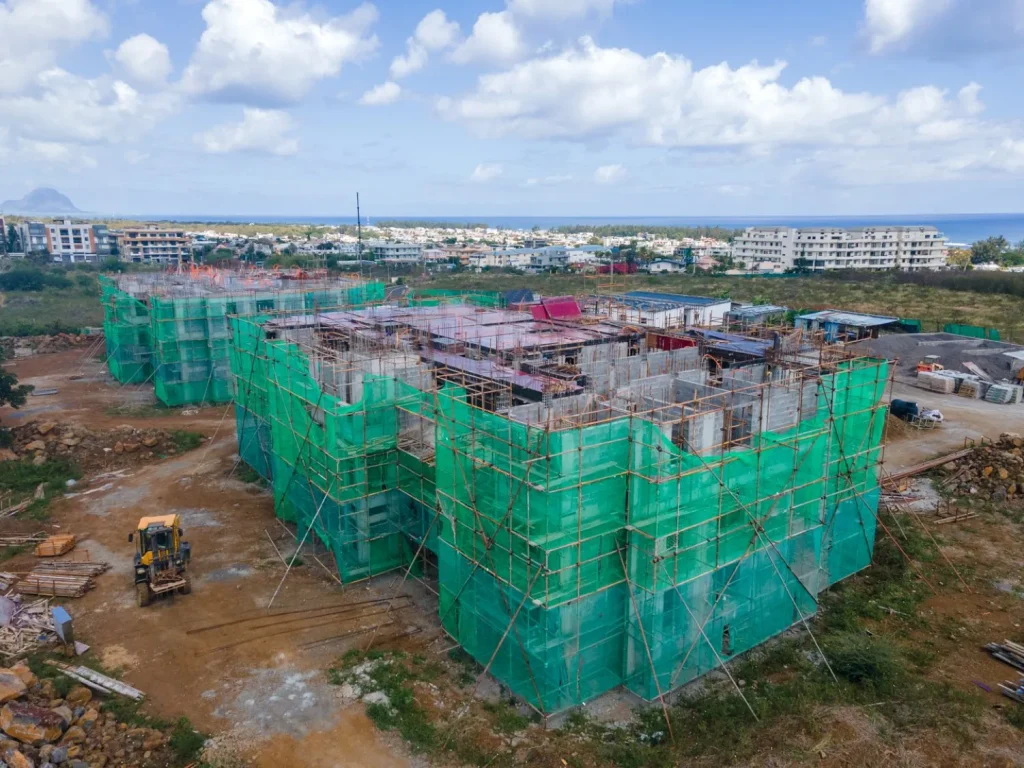Scaffolded elevations of both Anna City blocks with the coastline and Le Morne in the distance